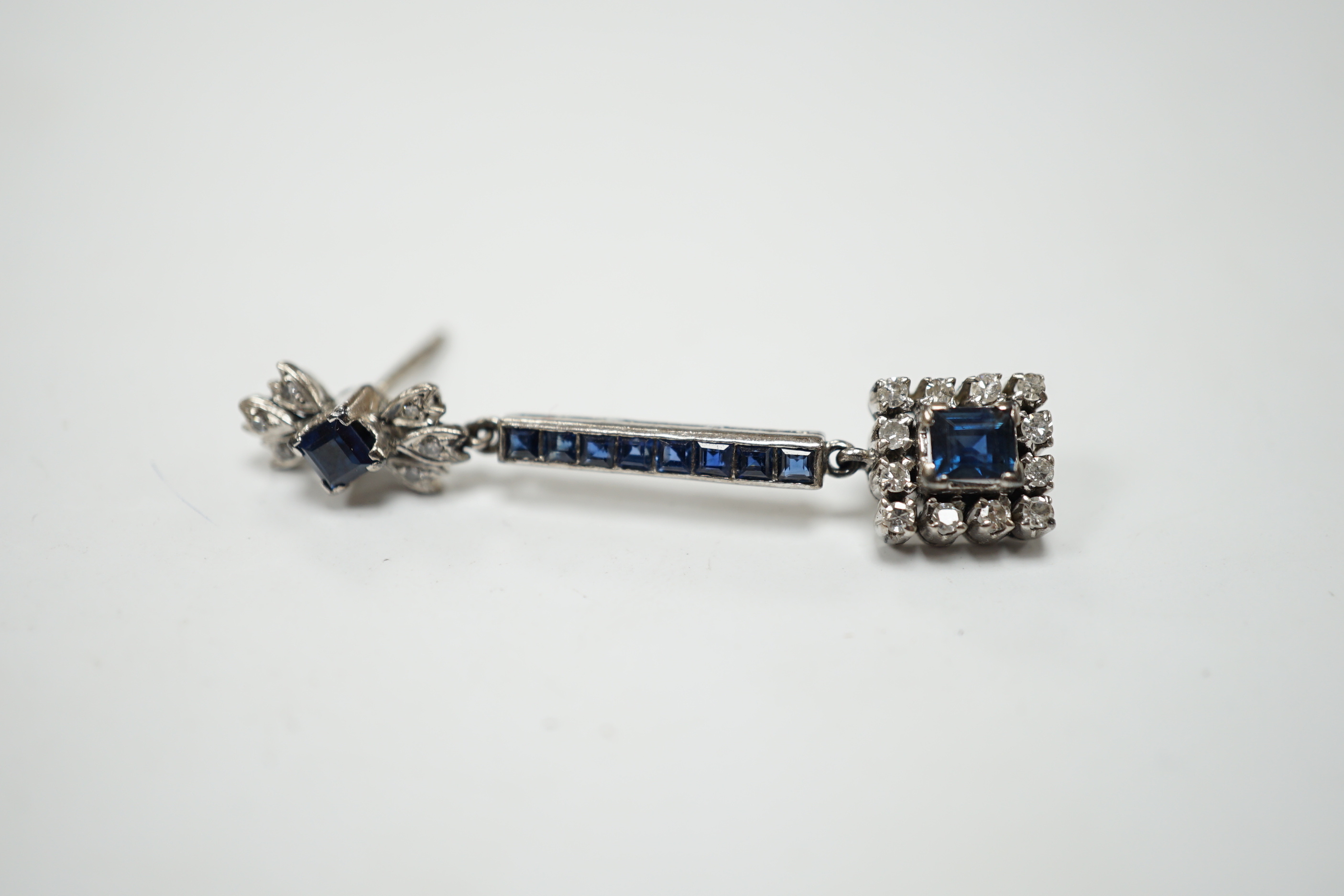 A single white metal (butterfly stamped 18), sapphire and diamond cluster set drop earring, 45mm, gross weight 4.1 grams.